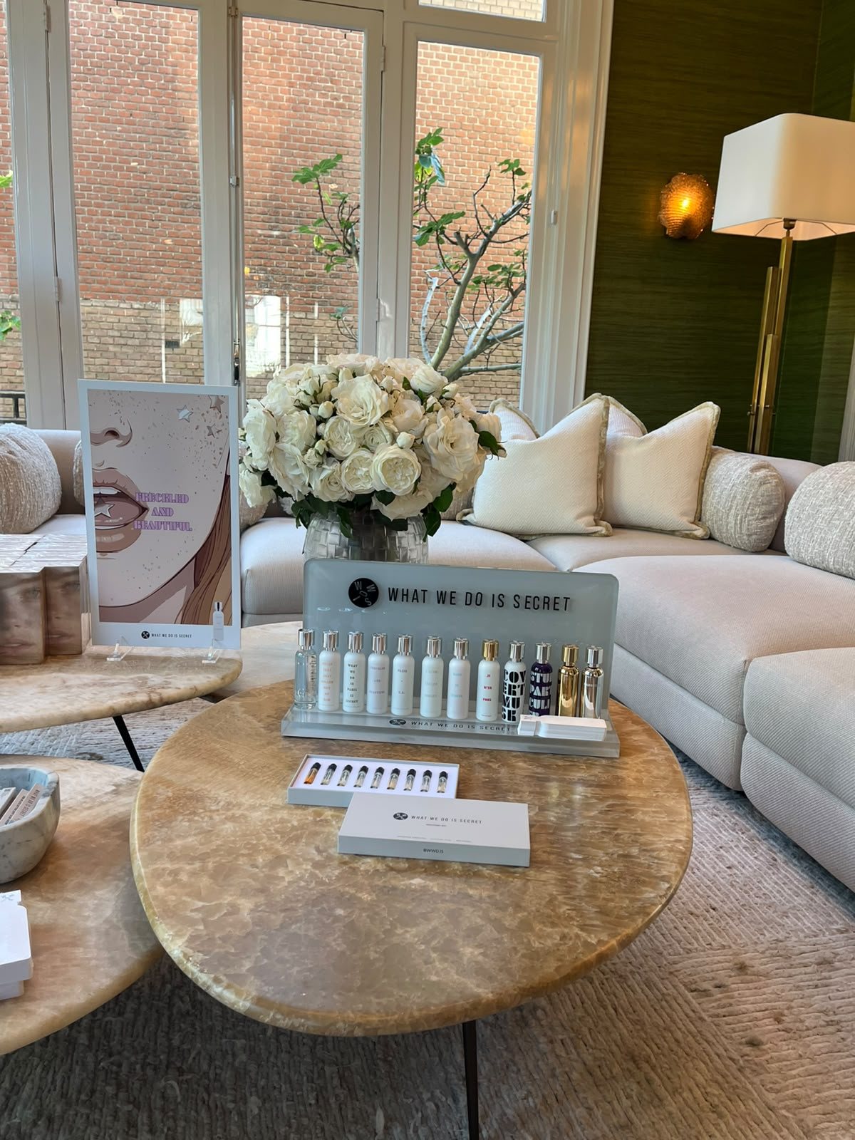 The display on a round onyx table in front of a window at the SKINS press day